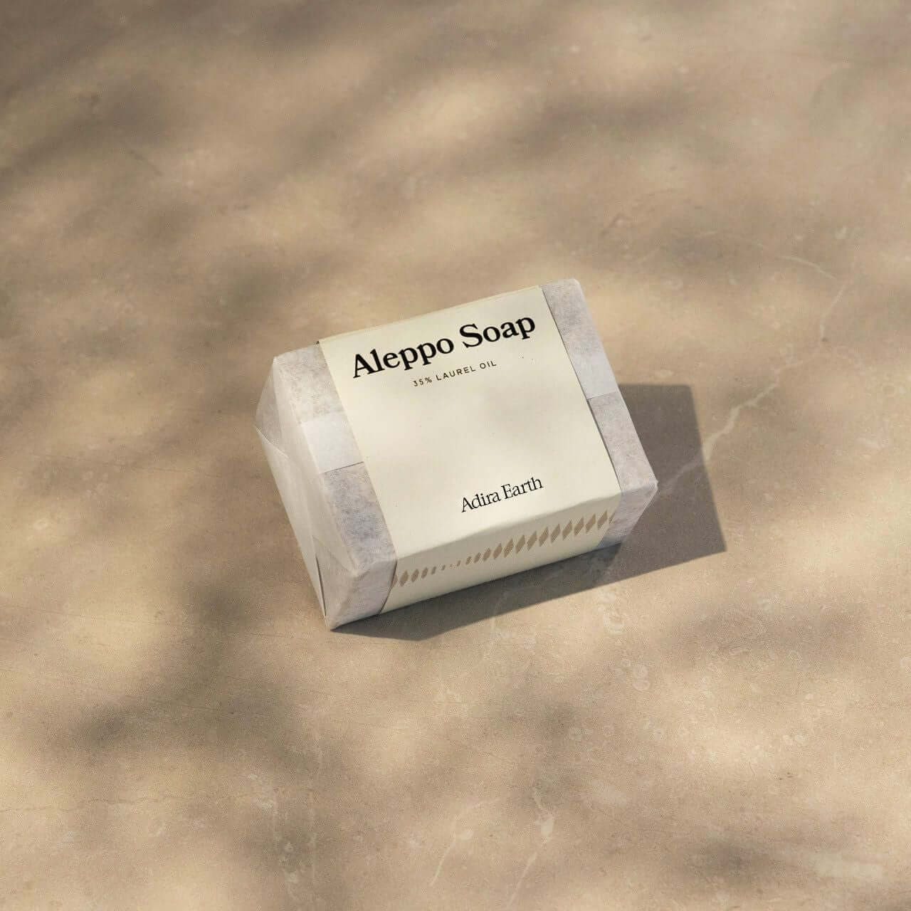 Aleppo Soap Bar on a neutral background, featuring nourishing olive and laurel oils for gentle cleansing and revitalization.