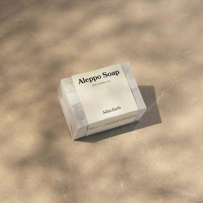 Aleppo Soap Bar on a neutral background, featuring nourishing olive and laurel oils for gentle cleansing and revitalization.