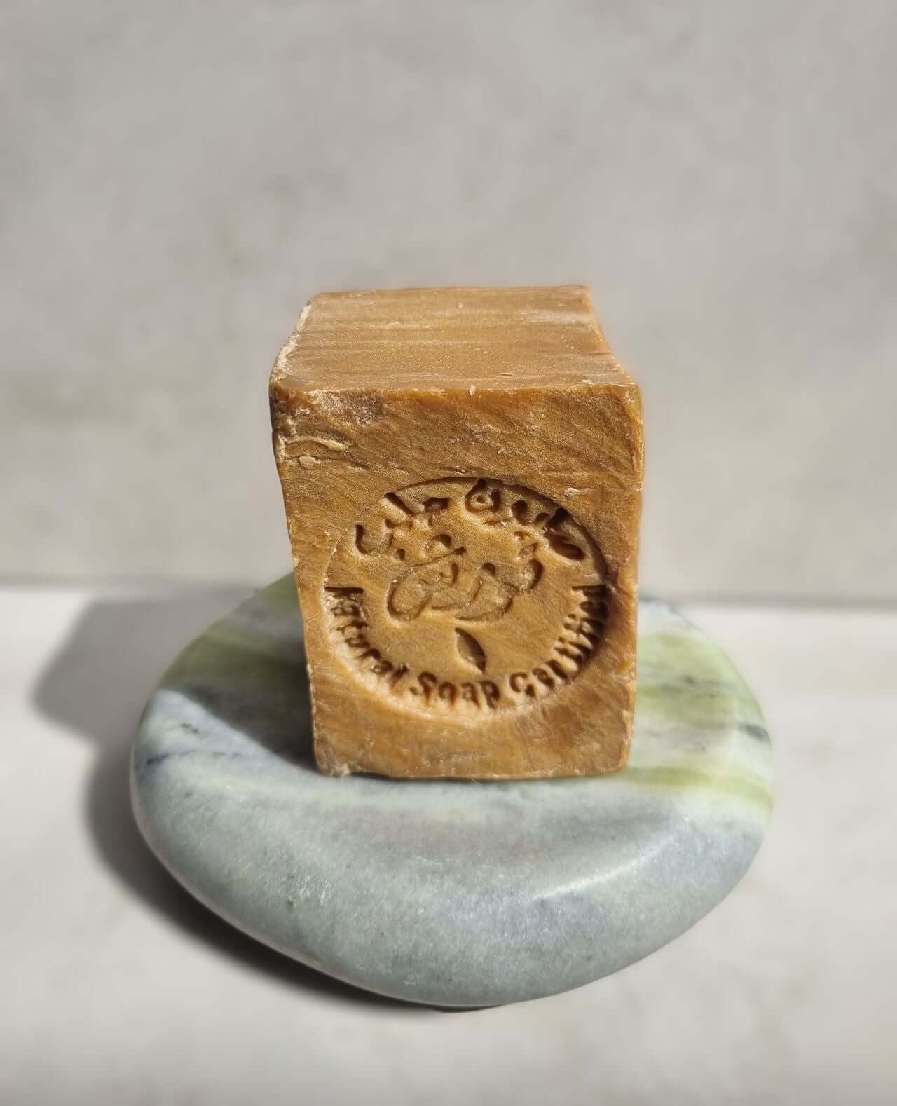 Marble soap dish with a natural soap bar, showcasing elegant bathroom decor and stylish design.