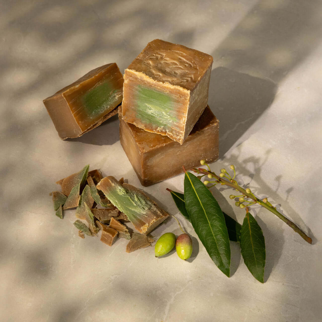 Bars of traditional Aleppo soap made with laurel and olive oils, showcasing natural skincare products from Adira Earth.