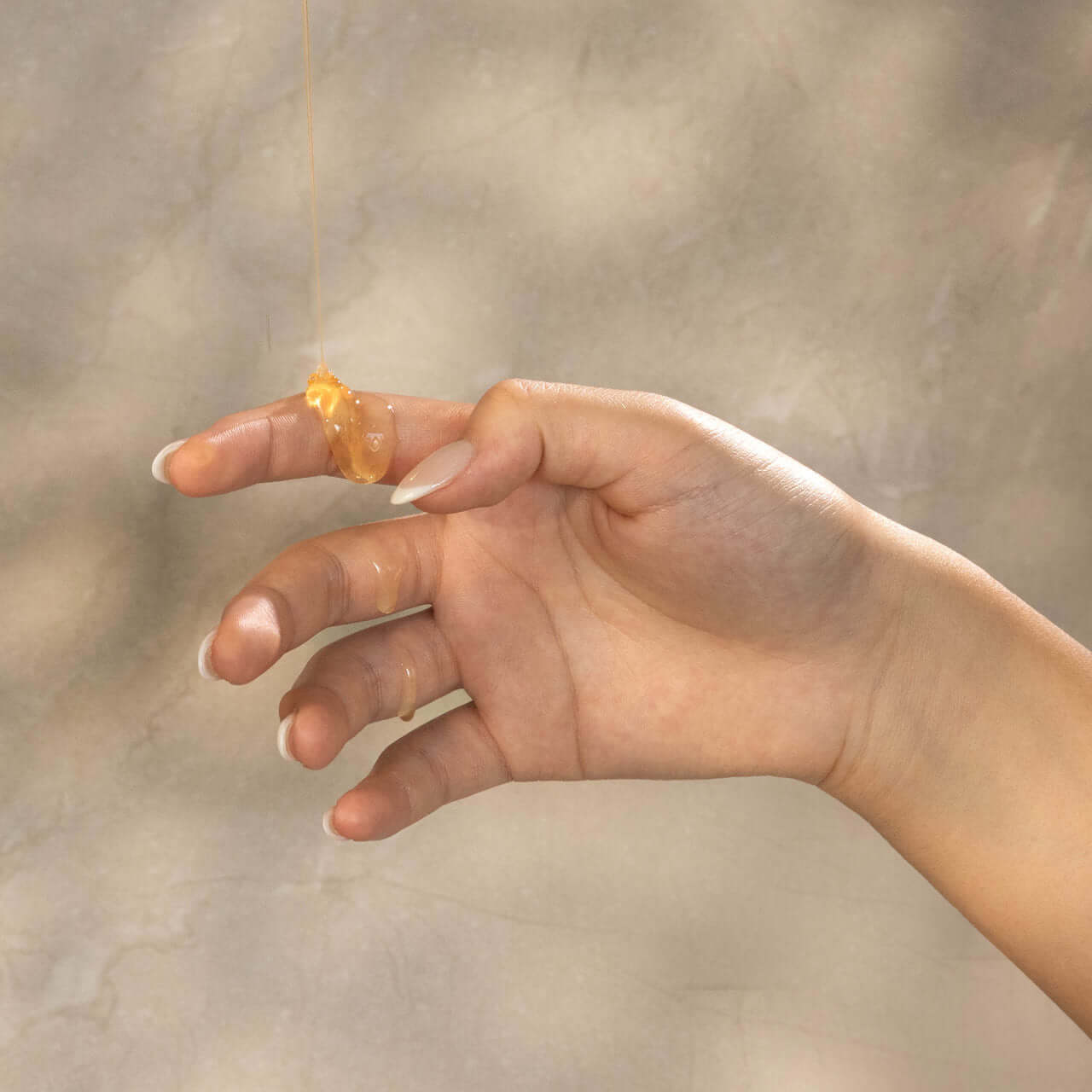 Hand with Aleppo soap gel emphasizing texture and natural ingredients.